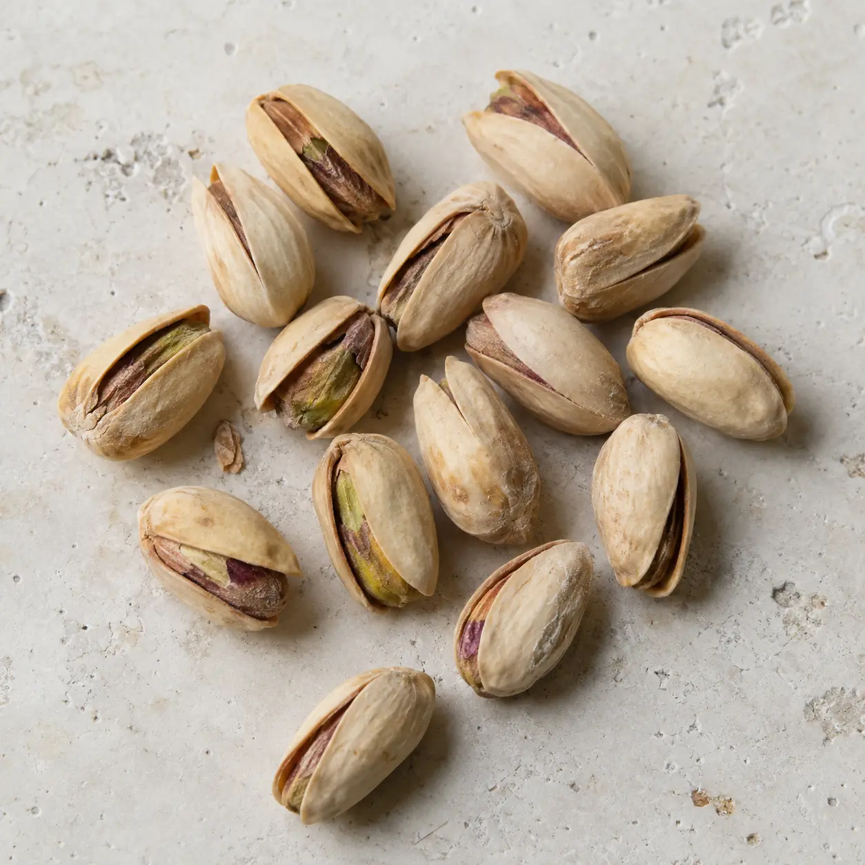 Akbari pistachios on a neutral background